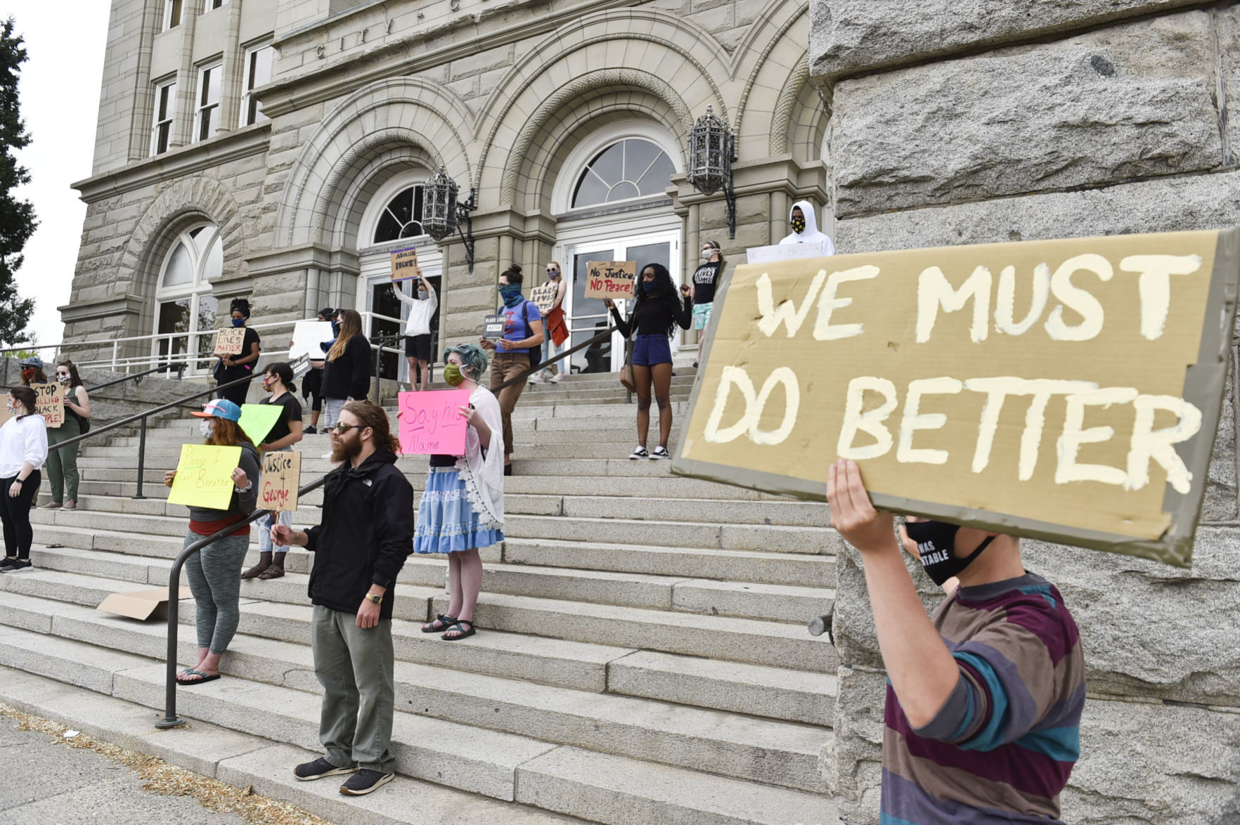 Protesters gather on the steps of the City-County Building Friday
